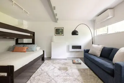 a bedroom with a bed and a couch at Epic architectural masterpiece views & hot tub in Accord