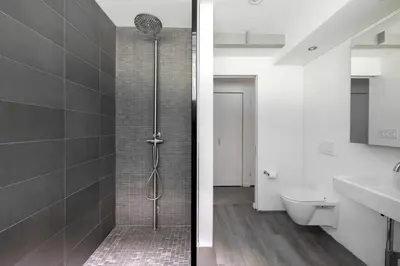 a bathroom with a shower with a toilet and a sink at Epic architectural masterpiece views & hot tub in Accord