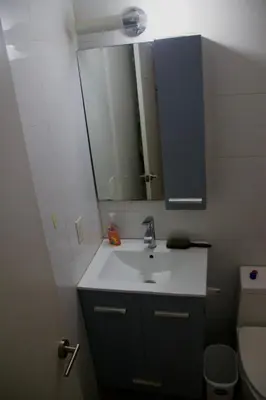a bathroom with a sink and a mirror and a toilet at Guest First b4 Anything in Fresh Pond