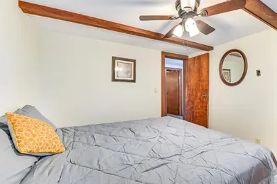 a bedroom with a bed and a ceiling fan at Lake-View Cabin with Furnished Deck in Hadley! in Hadley