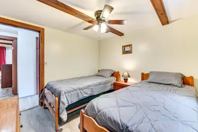 a bedroom with two beds and a ceiling fan at Lake-View Cabin with Furnished Deck in Hadley! in Hadley