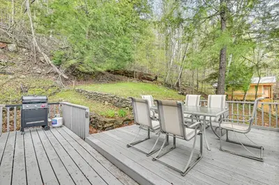 a deck with a table and chairs and a grill at Lake-View Cabin with Furnished Deck in Hadley! in Hadley