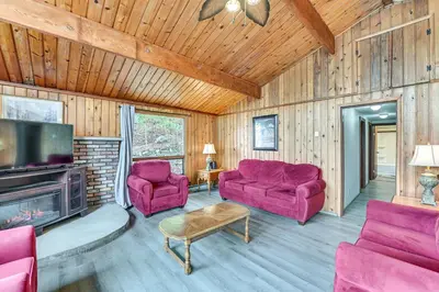 a living room with purple couches and a tv at Lake-View Cabin with Furnished Deck in Hadley! in Hadley