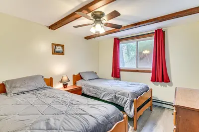 a bedroom with two beds and a window at Lake-View Cabin with Furnished Deck in Hadley! in Hadley