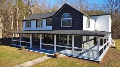 a blue and white house with a gambrel roof at Catskills Escape Hot Tub Massage Chairs & Games in Round Top
