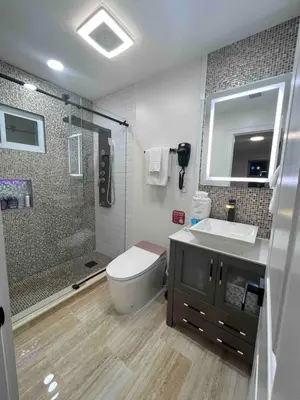 a bathroom with a toilet and a sink and a shower at Modern getaway in Catskills in Cairo