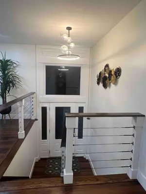 a staircase in a house with a window and a stair case at Modern getaway in Catskills in Cairo