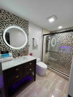 a bathroom with a sink and a toilet and a mirror at Modern getaway in Catskills in Cairo
