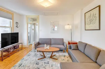 a living room with a couch and a table at 1 Mi to Dtwn Schenectady Apt in Stockade District in Schenectady