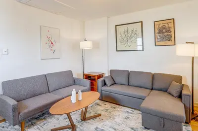 a living room with two couches and a table at 1 Mi to Dtwn Schenectady Apt in Stockade District in Schenectady