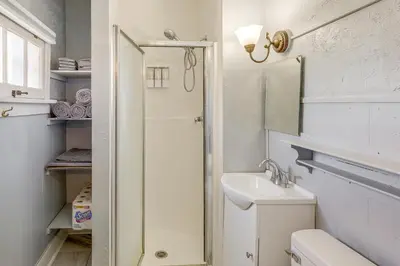 a bathroom with a toilet and a sink and a mirror at 1 Mi to Dtwn Schenectady Apt in Stockade District in Schenectady