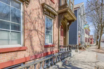 a brick building with a bench next to a street at 1 Mi to Dtwn Schenectady Apt in Stockade District in Schenectady