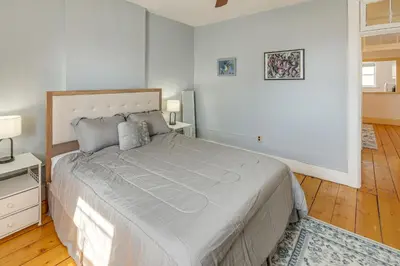 a bedroom with a large bed in a white room at 1 Mi to Dtwn Schenectady Apt in Stockade District in Schenectady