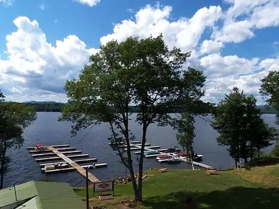 a bunch of boats are docked on a lake at Charming Camping Cabin on the Shores of Great Sacandaga Lake in Northville, New York in Northville
