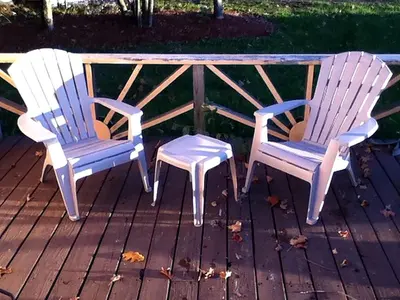 two chairs and a table on a deck at Charming Camping Cabin on the Shores of Great Sacandaga Lake in Northville, New York in Northville