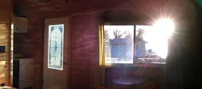 a room with a door and a window in a house at Charming Camping Cabin on the Shores of Great Sacandaga Lake in Northville, New York in Northville