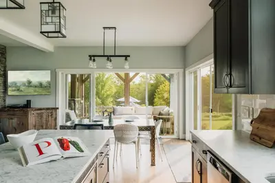 a kitchen with a table and a dining room at Elevated Catskills Getaway On 15-acre Private Farm in Parksville