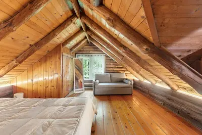 a bedroom with a bed and a couch in a attic at The Bears Nest in Boiceville
