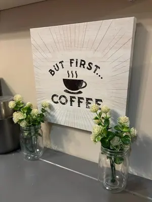 two vases with flowers and a sign that says first coffee at Masthope Heritage Chalet in Lackawaxen