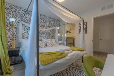a bedroom with a bed with a canopy at Opulence in Olive 4 bedrooms, 4 baths with 10 beds, Park 2 cars FREE in Orange