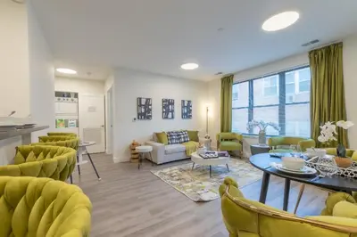 a living room with yellow chairs and a table at Opulence in Olive 4 bedrooms, 4 baths with 10 beds, Park 2 cars FREE in Orange