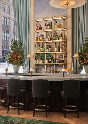 a bar at a hotel with chairs around it at The Wall Street Hotel by Suiteness in New York