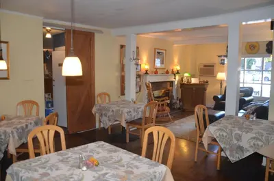 a dining room with tables and chairs and a fireplace at Cornwall Inn in Cornwall Bridge