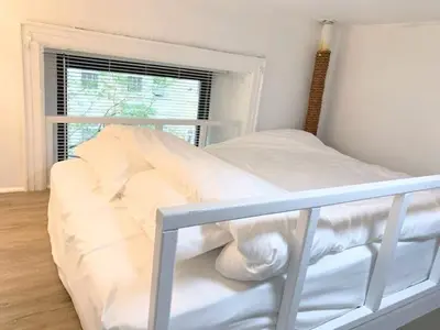 a white bed in a room with a window at Private room with Shared bath on Union Square 11 in New York