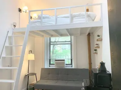 a living room with a bunk bed and a couch at Private room with Shared bath on Union Square 11 in New York
