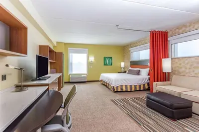 a hotel room with a bed and a television at Home2 Suites by Hilton Albany Airport/Wolf Rd in Albany