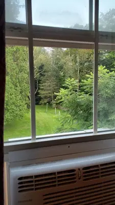 a window with a view of a field of trees at The Empire House Hotel and Restaurant in Gilbertsville