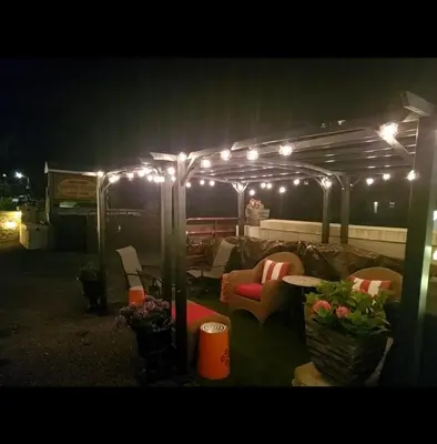 a group of chairs under a tent with lights at The Empire House Hotel and Restaurant in Gilbertsville