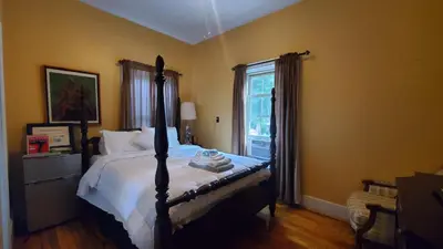 a bedroom with a bed and a window at The Empire House Hotel and Restaurant in Gilbertsville