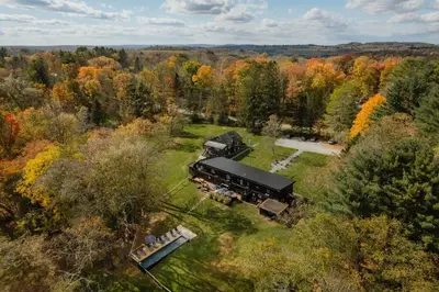 an aerial view of a house in the middle of a forest at Coop 003 in Kenoza Lake