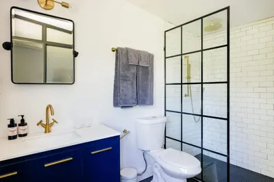 a bathroom with a toilet and a glass shower at Coop 004 in Kenoza Lake