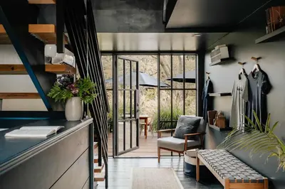 a living room with a couch and a chair at Suite 001 in Kenoza Lake