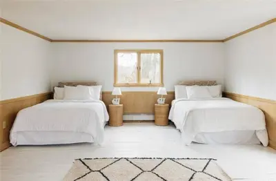 two beds in a white room with a window at Catskills ChestnutCreek+Swimming Hole+Firepit+Hike in Neversink