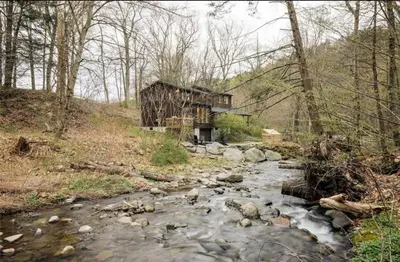 an old building next to a stream in the woods at Catskills ChestnutCreek+Swimming Hole+Firepit+Hike in Neversink