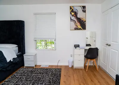 a bedroom with a bed and a desk and a chair at Anike's Place in Newark
