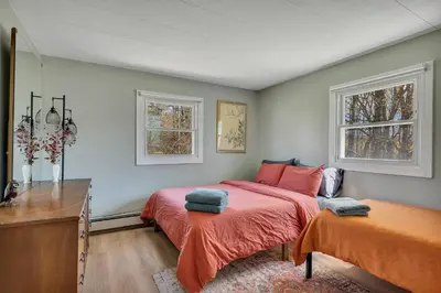 a bedroom with two beds and two windows at Charming Retreat Walking in Tannersville