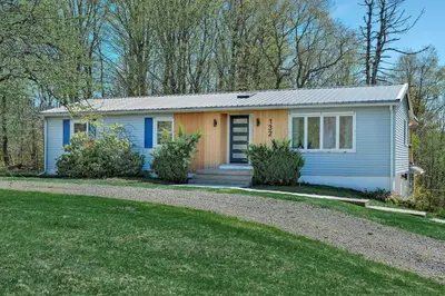 a small blue and yellow house with a driveway at Charming Retreat Walking in Tannersville