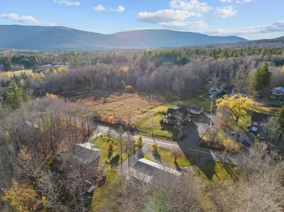 an aerial view of a field with a train on the tracks at Charming Retreat Walking in Tannersville