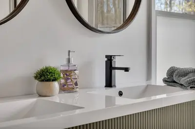 a bathroom sink with a faucet and a mirror at Charming Retreat Walking in Tannersville