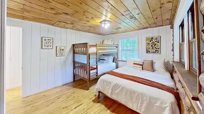 a bedroom with a bed and a bunk bed at Cozy Berkshires Cabin with Lake, Beach, Hot Tub, Fireplace - The Wilde BNB