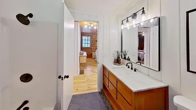 a bathroom with a sink and a mirror at Cozy Berkshires Cabin with Lake, Beach, Hot Tub, Fireplace - The Wilde BNB