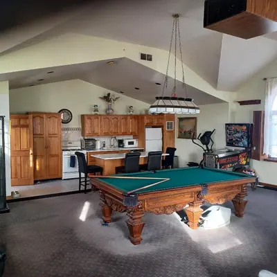 a kitchen with a pool table in a living room at The Lordship Loft in Stratford