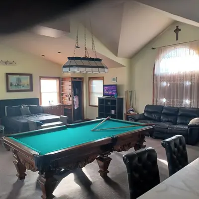 a living room with a pool table in it at The Lordship Loft in Stratford
