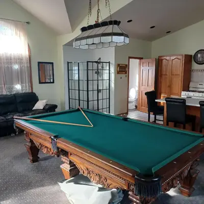 a living room with a pool table in it at The Lordship Loft in Stratford