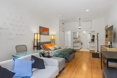 a living room with a couch and a table at Stylish Studio in Central Park Best Location Ever in New York