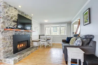 a living room with a couch and a fireplace at 2 Mi to Mt Snow Cozy Family Alpine Retreat! in Wardsboro